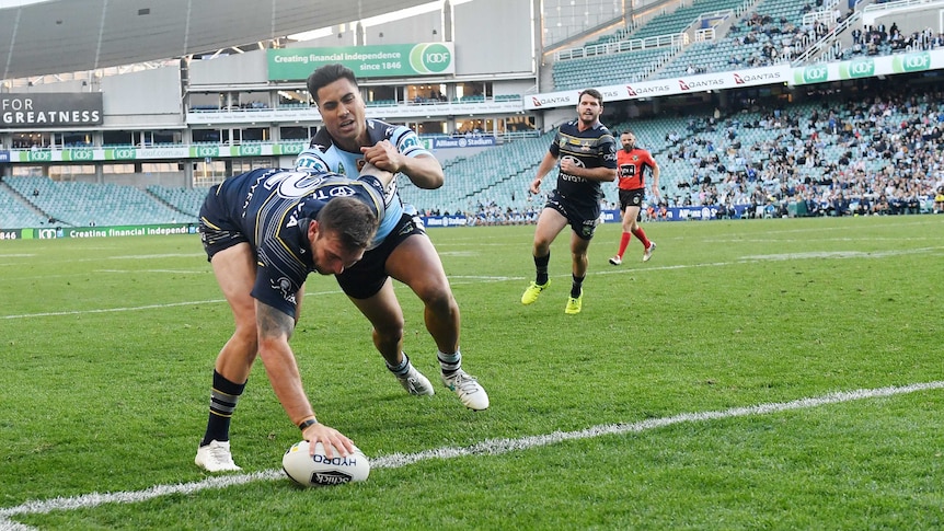 Kyle Feldt (left) of the Cowboys scores a try in the elimination final against Cronulla.