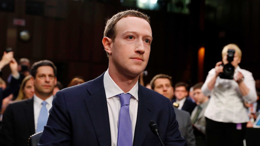 Facebook chief executive Mark Zuckerberg listens to opening statements while testifying.