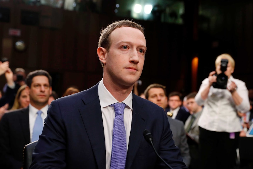 Facebook chief executive Mark Zuckerberg listens to opening statements while testifying.