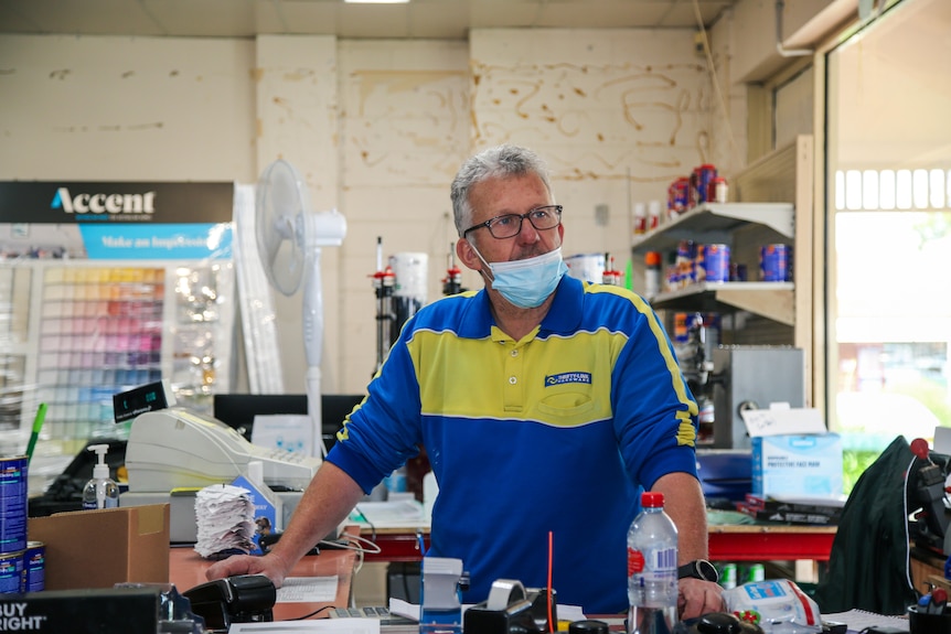 A man at the counter in a hardware store