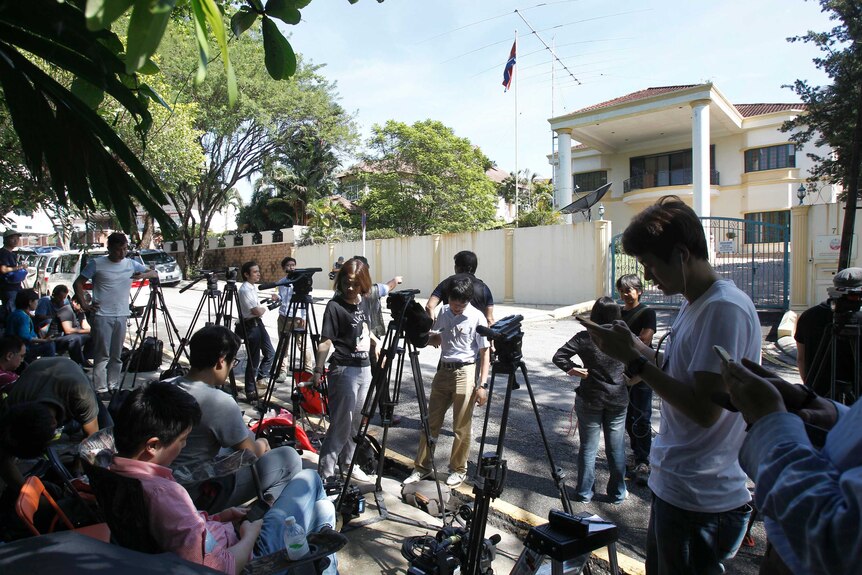 Television cameras and reporters waiting on the road outside the North Korean Embassy in Kuala Lumpur.