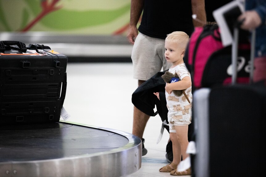Toddler waiting for luggage 