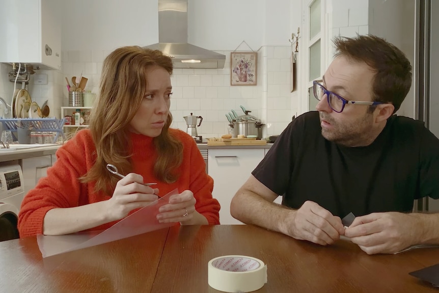 A scene from web series Cancelled where a woman and a man are making face masks using plastic