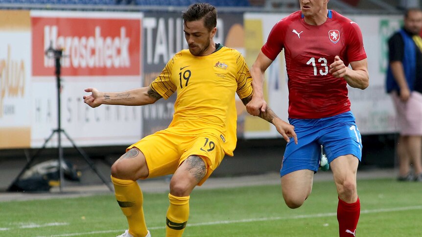 Australia's Joshua Risdon (L), and Czech's Jan Kopic (R), challenge for the ball in a friendly.