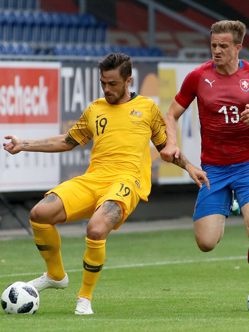 Australia's Josh Risdon and Czech Republic's Jan Kopic challenge for the ball