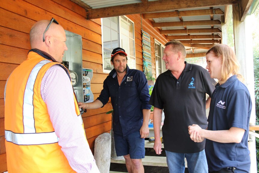 Bruny Island resident John Kobylec with power supplies installers