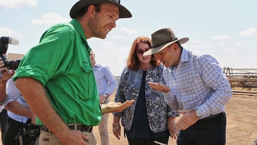 Ord farmer Christian Bloecker shows Prime Minister Tony Abbott some chia grown at his farm near Kununurra in the East Kimberley.