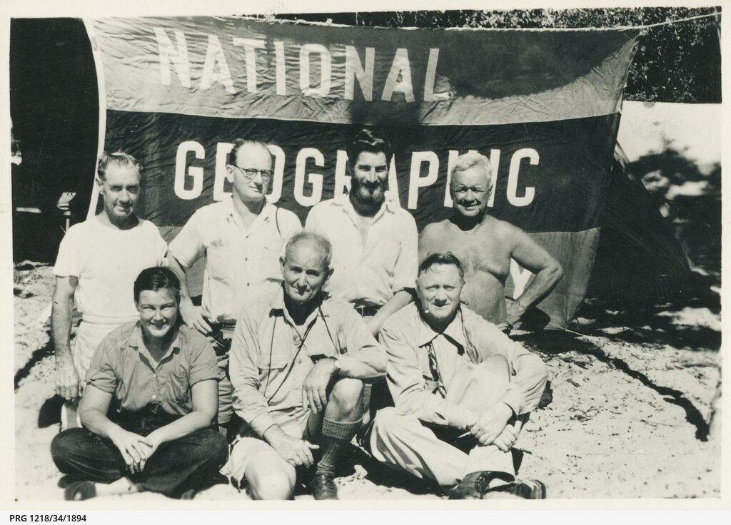Members of the "National Geographic" expedition to the Tiwi Islands pictured in front of the National Geographic Society flag.