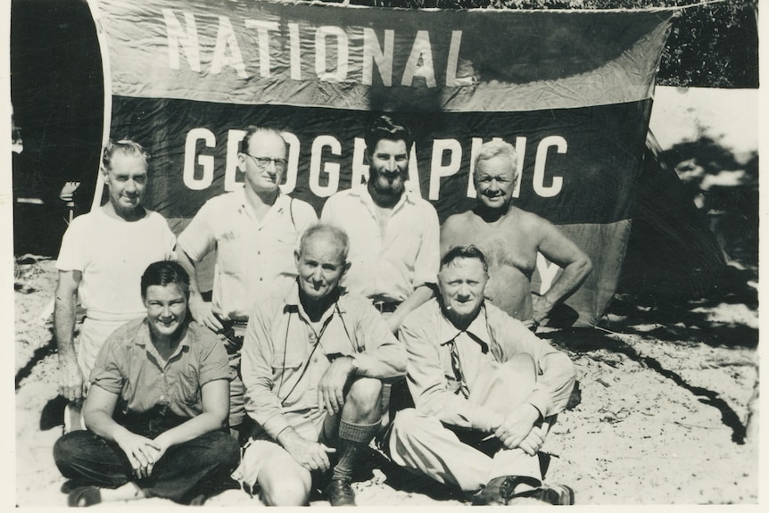 Members of the "National Geographic" expedition to the Tiwi Islands pictured in front of the National Geographic Society flag.