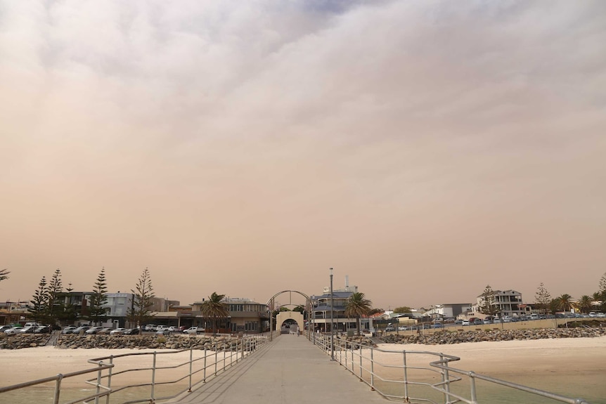 A photo of the sky showing the impact of a dust storm across Brighton Beach