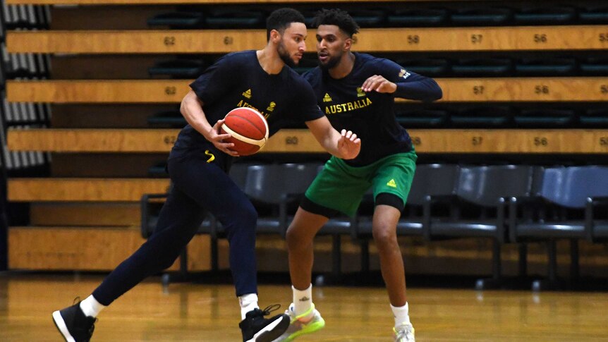 An Australian basketballer dribbles past an opponent during a drill at a Boomers training camp.