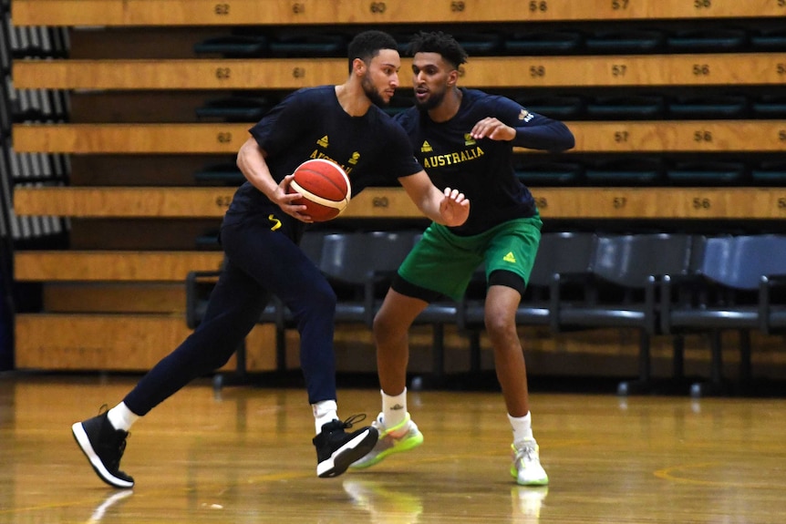 An Australian basketballer dribbles past an opponent during a drill at a Boomers training camp.