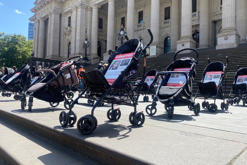 An image of strollers lined up in front of Victoria's Parliament House.