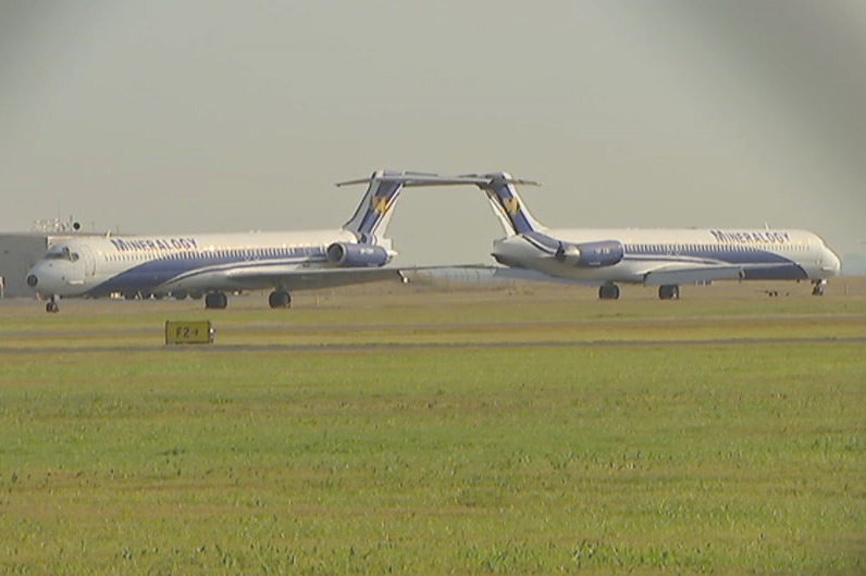 Two planes owned by Clive Palmer, branded with the name of one of his companies Mineralogy, at Brisbane airport.