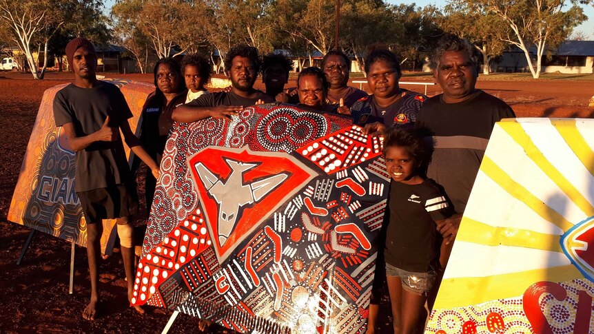 a group of people stand in front of the bonnet art