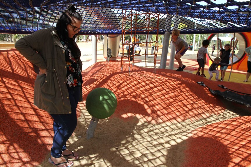 Jessi Arnold looking for knives in the sand at Rockhampton playground