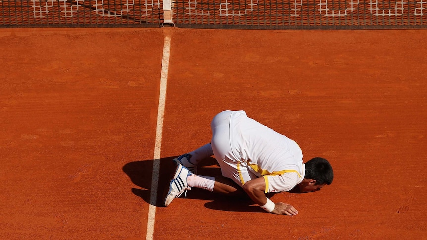 Monte Carlo master ... Novak Djokovic kisses the court after beating Rafael Nadal