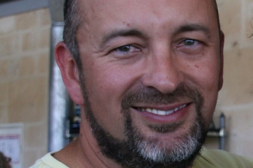 Close-up portrait of a man with sunglasses on his head, beard and moustache