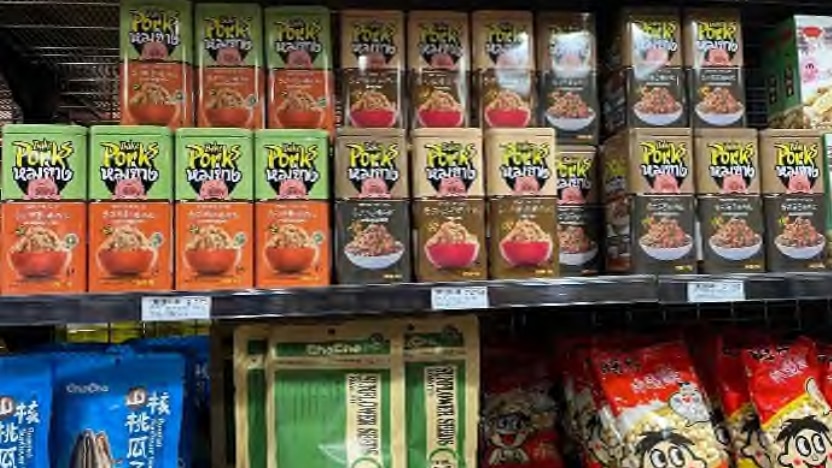 Shelf of tinned pork floss product on a supermarket shelf.