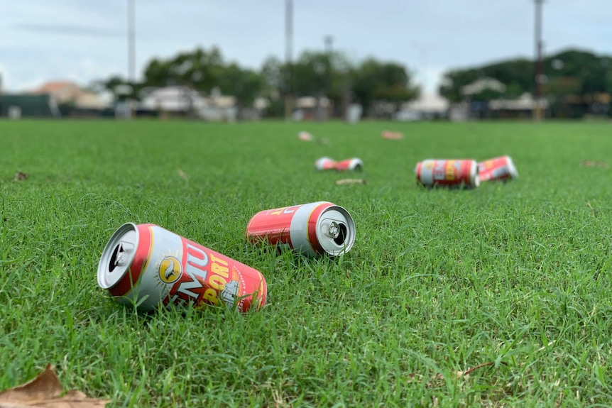 Image of multiple empty cans of beer that have been discarded on a sporting oval in Broome.