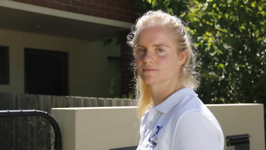 A woman stands outside a unit in Canberra.