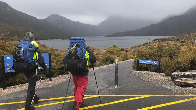 A pair of hikers walk along a path at a hike at Cradle Mountain in Tasmania