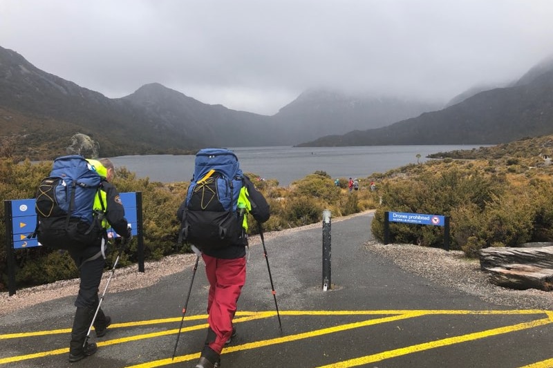 A pair of hikers walk along a path at a hike at Cradle Mountain in Tasmania