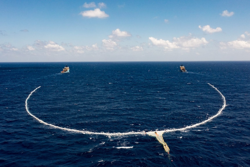 Two ships dragging a net.