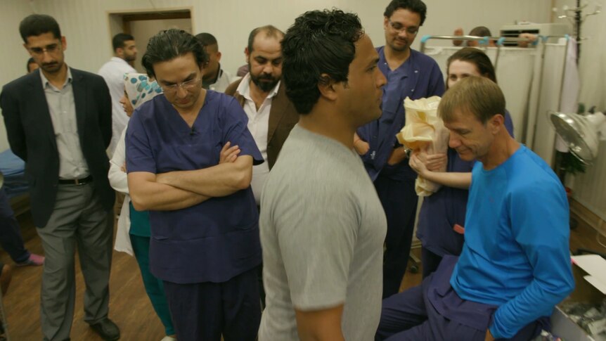 Dr Munjed Al Muderis watches Ali Bassam learning to walk again.