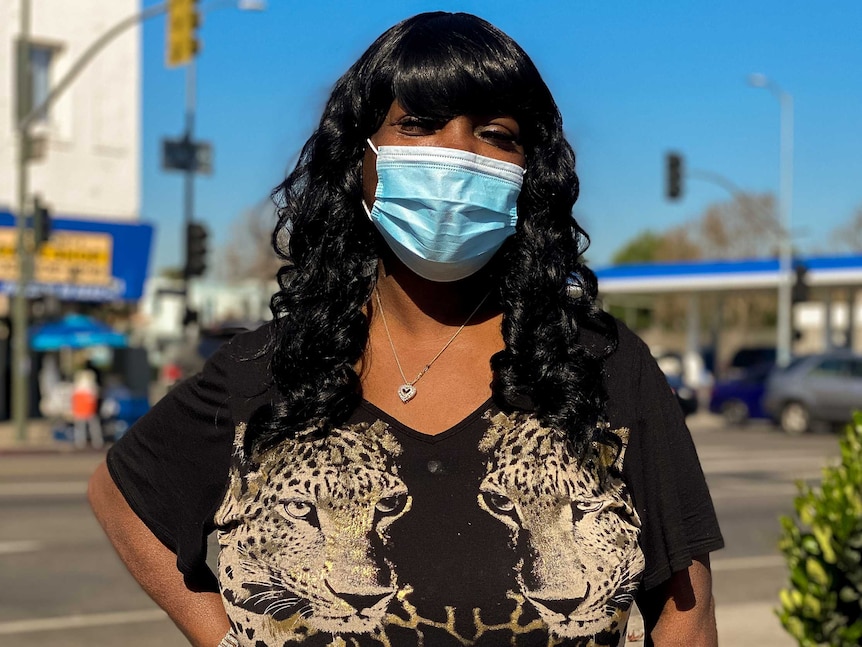 A black woman in a blue face mask