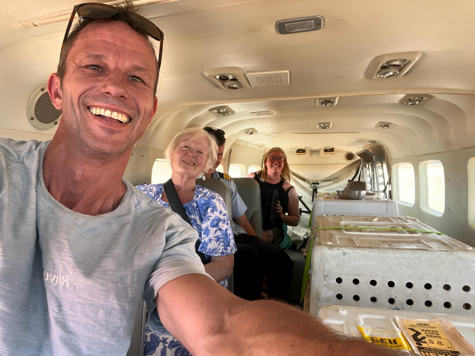 Four people pose for a selfie inside a plane at Newman airport. 