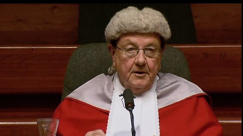 Judge sitting at desk in court dress