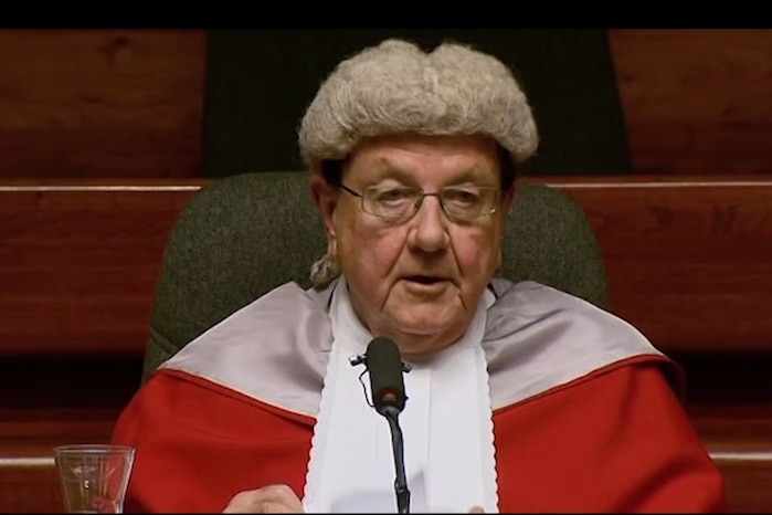 Judge sitting at desk in court dress