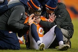 Denver Broncos' David Bruton gets attention after suffering a reported concussion against Oakland.