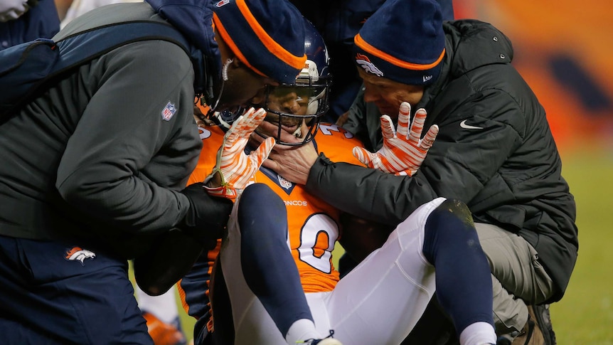Denver Broncos' David Bruton gets attention after suffering a reported concussion against Oakland.
