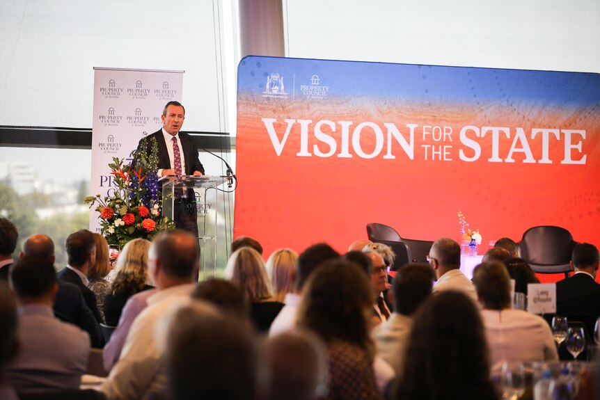 WA premier Mark McGowan speaks at a lectern next to a sign that says 'Vision for the State'