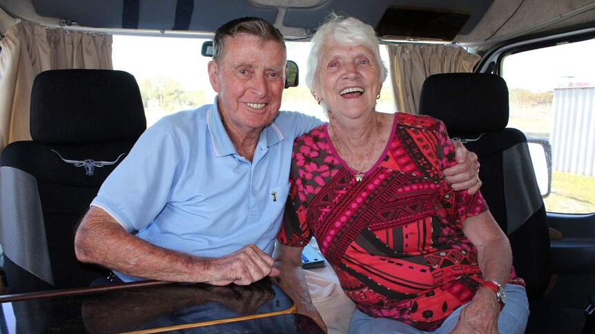 Ed and Jan Taylor sit at the dining table inside their motorhome.