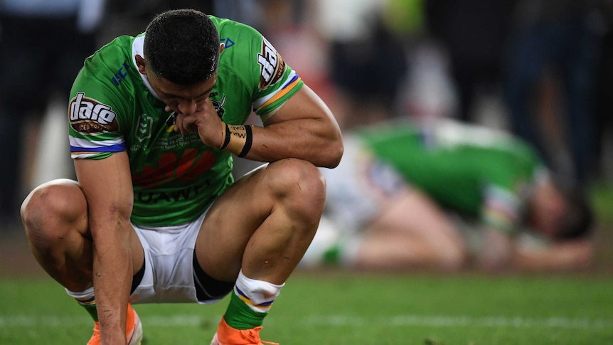 Canberra Raiders players on their haunches.
