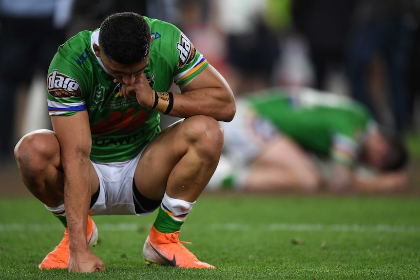 Canberra Raiders players on their haunches.