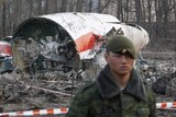 A Russian serviceman stands guard near wreckage