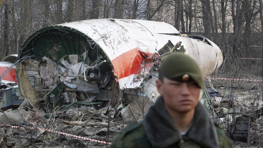 A Russian serviceman stands guard near wreckage