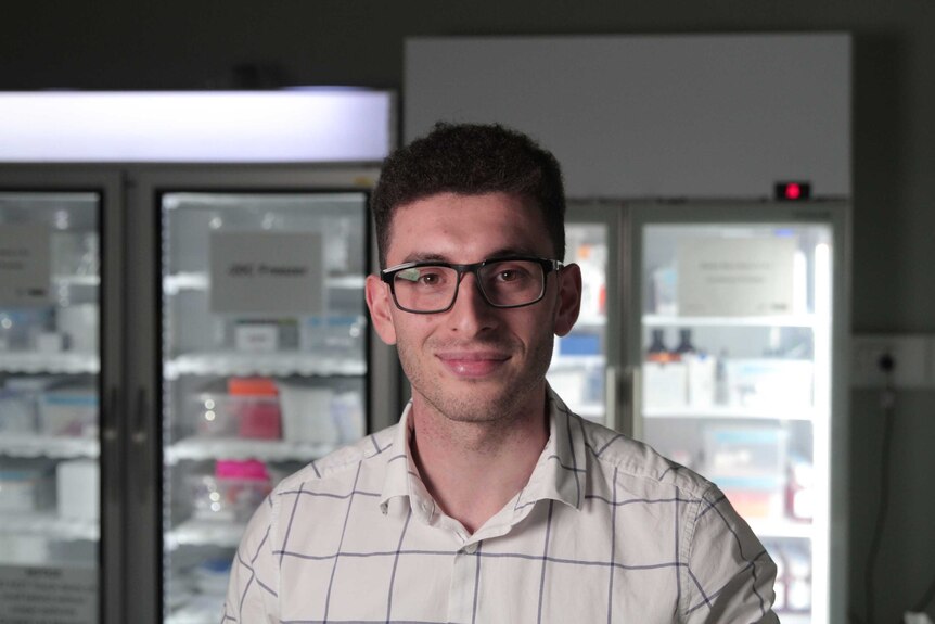 Anthony Kirollos standing in front of fridges in the UTS lab