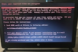A computer screen with a message from cyber attackers to pay a ransom in bitcoin currency.