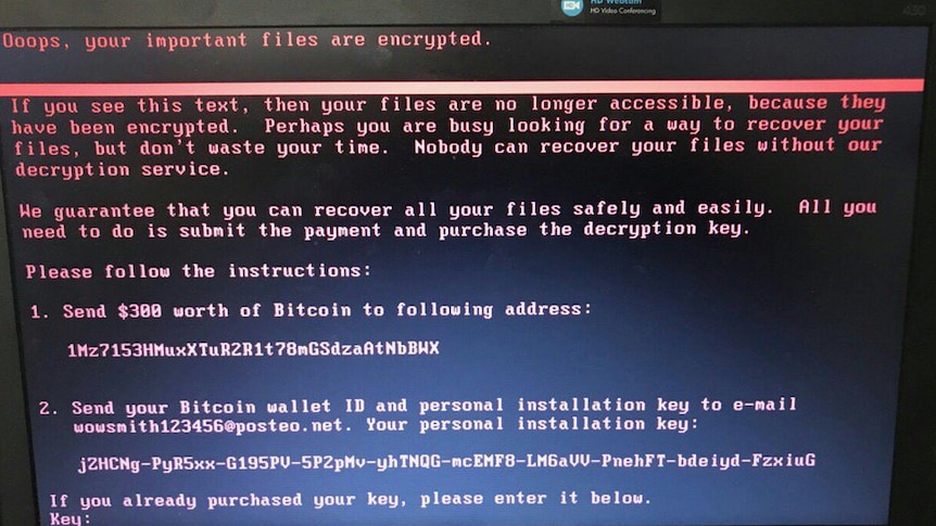 A close-up of a computer screen shows an ominous message from hackers demanding Bitcoin