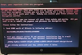 A close-up of a computer screen shows an ominous message from hackers demanding Bitcoin
