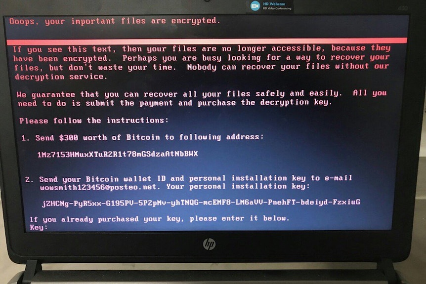 A computer screen with a message from cyber attackers to pay a ransom in bitcoin currency.