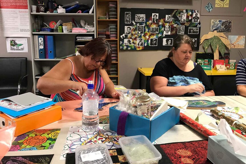 Sheree Bull and Christie Brown create Christmas artwork at at the Red Cross drop in centre in Rockhampton.