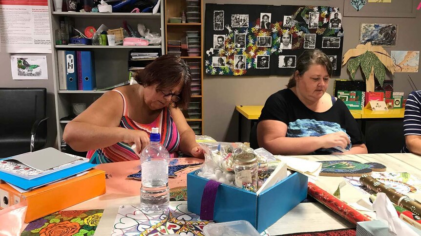 Sheree Bull and Christie Brown create Christmas artwork at at the Red Cross drop in centre in Rockhampton.