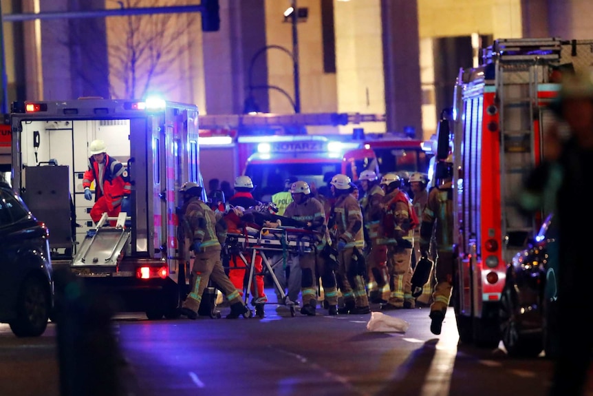 An injured person is loaded into an ambulance at Breitscheidplatz square.