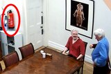 Assange and Robertson sit at a meeting table.